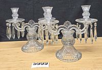 Pair of glass 2-light candelabra showing overall design and prisms
