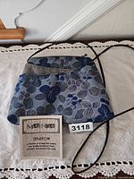 Full view of Maruca Sparrow floral handbag with information card