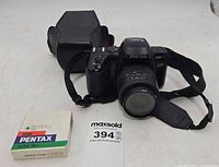 Front view of Pentax PZ-70 camera with lens, case, boxed filter visible