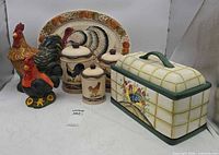 Group shot showing turkey platter, three rooster canisters, two rooster jars, bread box