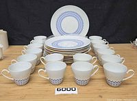 Full set showing all 16 cups and 10 plates with pattern visible