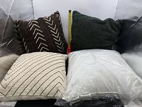 All four pillows side by side showing patterns, textures and packaging