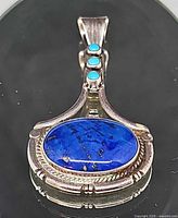 Front view of pendant showing blue cabochon and turquoise stones
