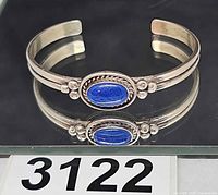 Full view of sterling silver cuff bracelet with blue stone