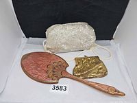Overall lot showing mirror, gold mesh purse, white beaded bag