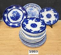 Front view showing stack of flow blue plates and three displayed plates