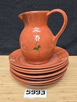 Pitcher on stack of plates showing overall lot