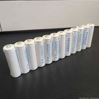 Row of twelve white Peyesten AA rechargeable batteries