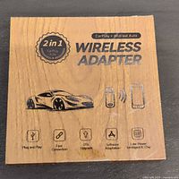 Closed wood-grain box top showing product name and icons