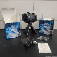 Fan on stand with accessories and two product boxes