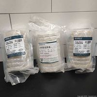 Three vacuum-sealed packs containing stacks of agar plates
