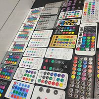 Top view of assorted LED remotes showing button layouts