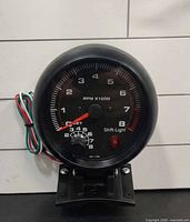 Gauge out of packaging showing face, wiring and bracket