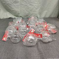 Group of clear ornament balls in packaging on surface