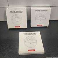 Front view of three boxed vibration sensor alarms