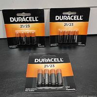 Front view showing three sealed Duracell 21/23 battery 4-packs
