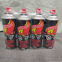 Front view of four shrink-wrapped Perfect 227 g butane cartridges