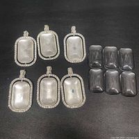 Six pendants and six glass covers laid out