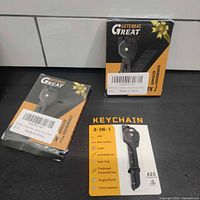 Three boxed 8-in-1 keychain multi-tools, two sealed and one opened for display