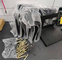 stack of steel post brackets with hardware