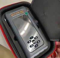 Jump starter in carrying case showing control buttons and display