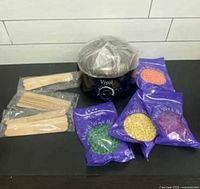 Wax warmer, four colored wax bead packs, two bundles of applicator sticks