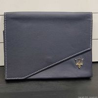 Front view of blue leather Maserati manual case showing entire item