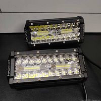Two NAOEVO 7" LED light bars showing fronts, housings, and wiring