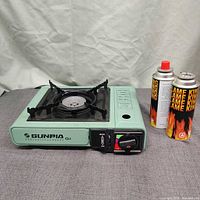 Stove with burner grate, control panel and two fuel canisters