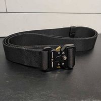 Coiled tactical belt showing overall length and buckle