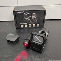 Sight, laser active, box and lens cover visible