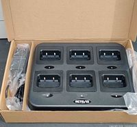 Top view of six-slot Retevis charger inside box with adapter packaged