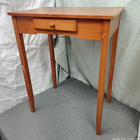 Front view of solid wood Shaker style end table highlighting drawer and tapered legs