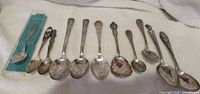 All 11 souvenir spoons laid out