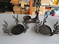Front view of all three metal deer candle holders