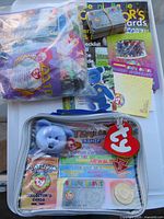 Overview showing sealed toys bag, collector kit pouch and card stack