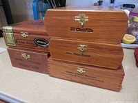 Stack showing five branded cigar boxes front view