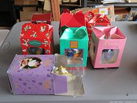 All seven ornament boxes on table