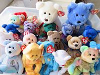 Bin containing two larger bears and multiple smaller bears with Ty tags visible