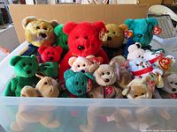 Plastic bin containing assorted Ty Beanie Buddies and Beanie Babies plush bears
