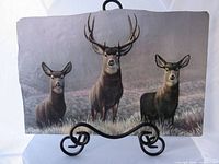 Front view showing mule deer image on slate plaque with stand