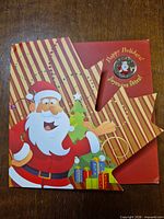 Front of holiday card packaging with Santa graphic