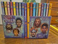 Front view of all 18 Animorphs paperbacks arranged between two Animorphs slipcases, showing spine numbers and titles
