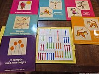 open case with arrow tiles and five booklets visible