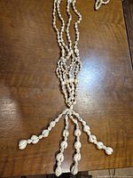Full length view of seashell strands and tassel ends