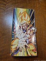 Front cover of Dragon Ball Z binder showing Super Saiyan Goku art and snap button
