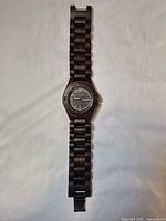 Full view of wooden wristwatch with band extended