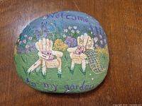 Full view of painted rock front showing complete design and text