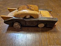 left side view showing overall shape, wooden wheels and color variation