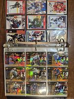 Open binder showing two pages of holographic Upper Deck cards and standard issue cards